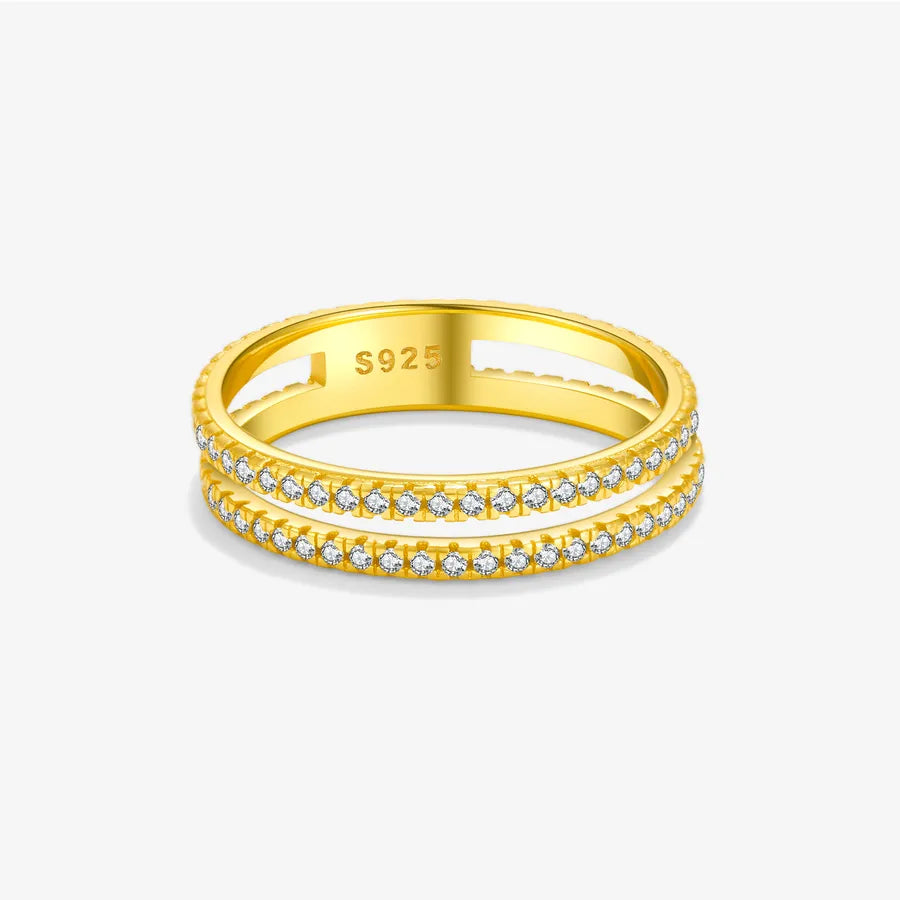 A yellow gold double-band ring with pavé-set clear stones on the front, shown on a light gray background. The inside of the band is stamped with 'S925'.