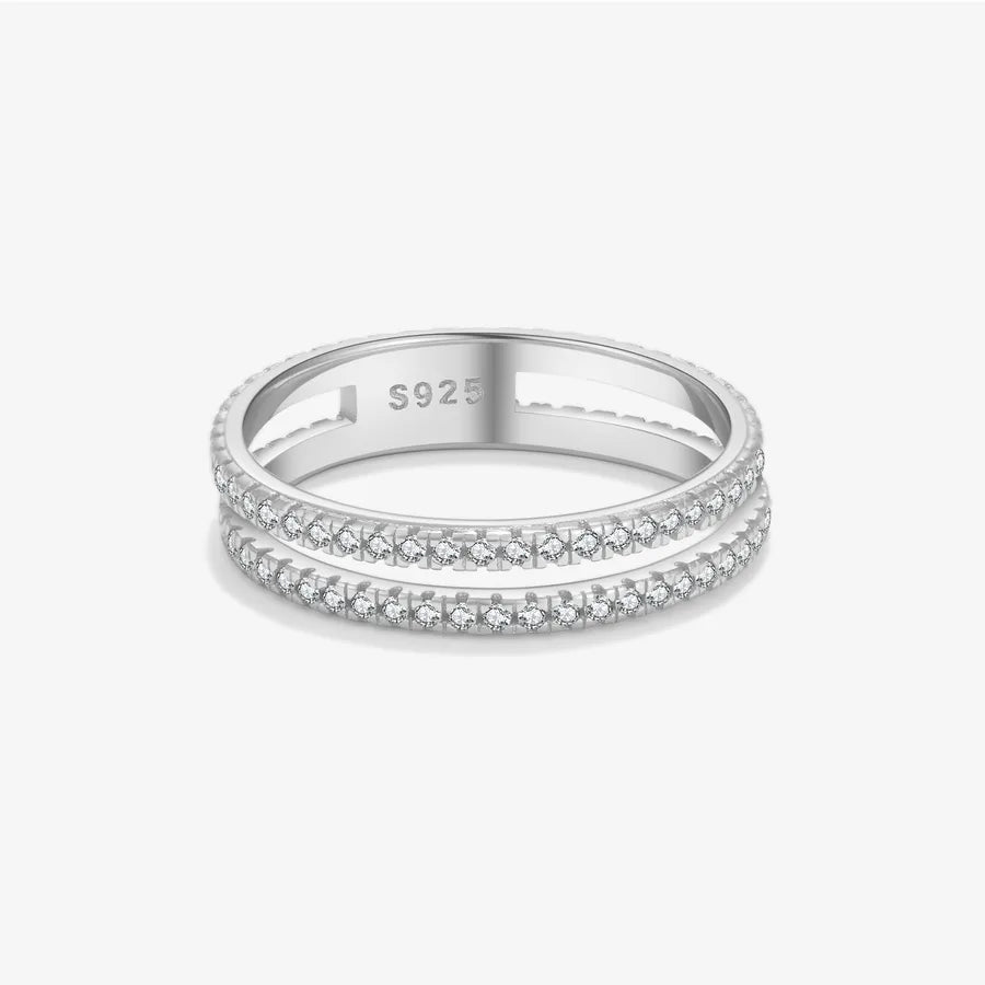 A silver double-row diamond eternity ring with a polished band, featuring a 'S925' sterling silver hallmark inside, set against a clean light gray background.