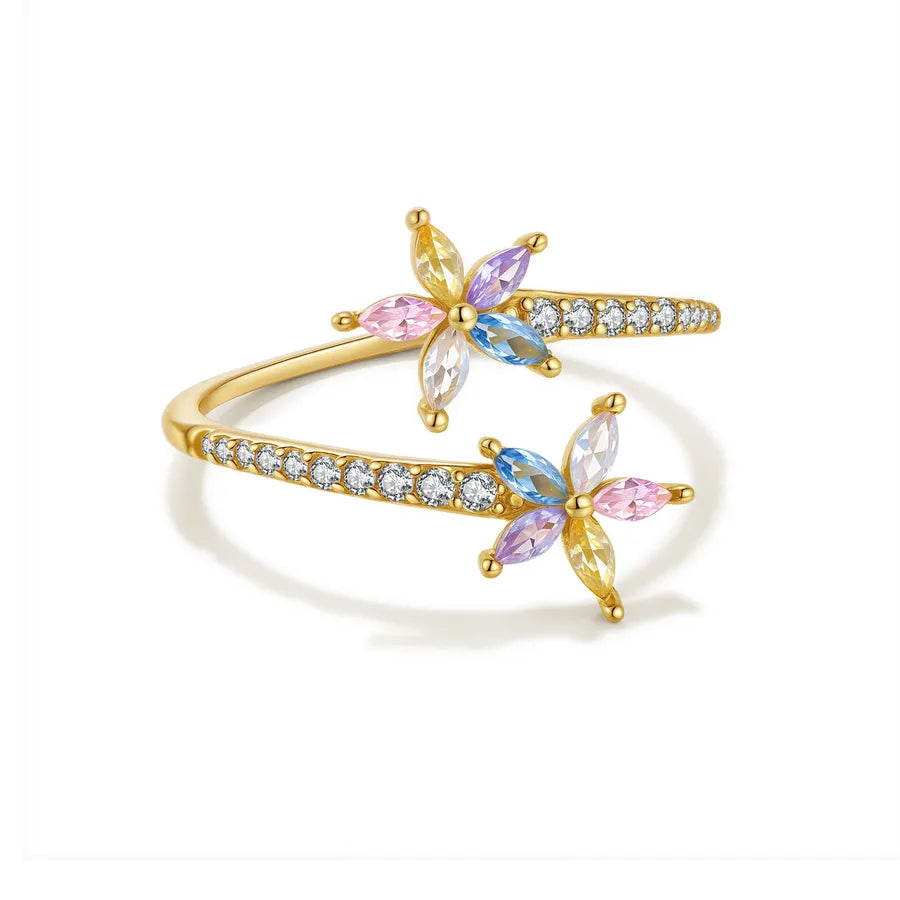 A gold open bangle ring decorated with two butterfly motifs and rows of small clear stones, shown on a clean white background.