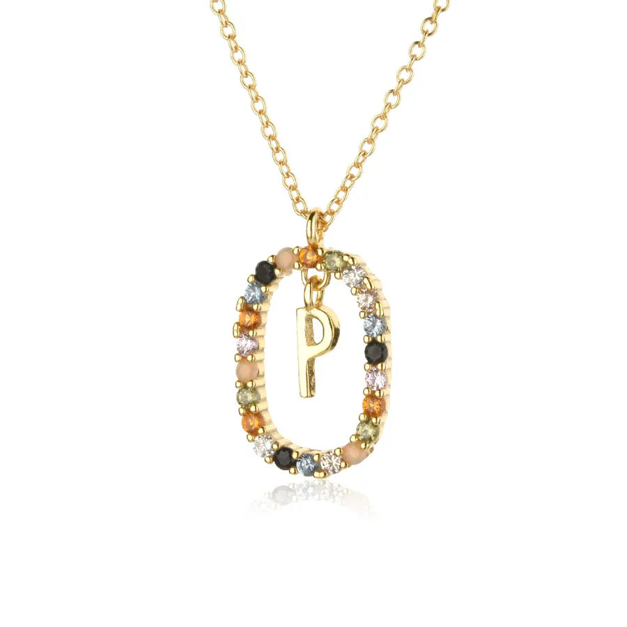 Gold necklace with a circular pendant featuring the letter 'P' and multicolored stones on a white background.