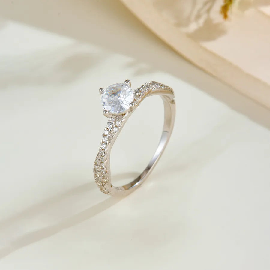 Silver ring with a diamond on a light background