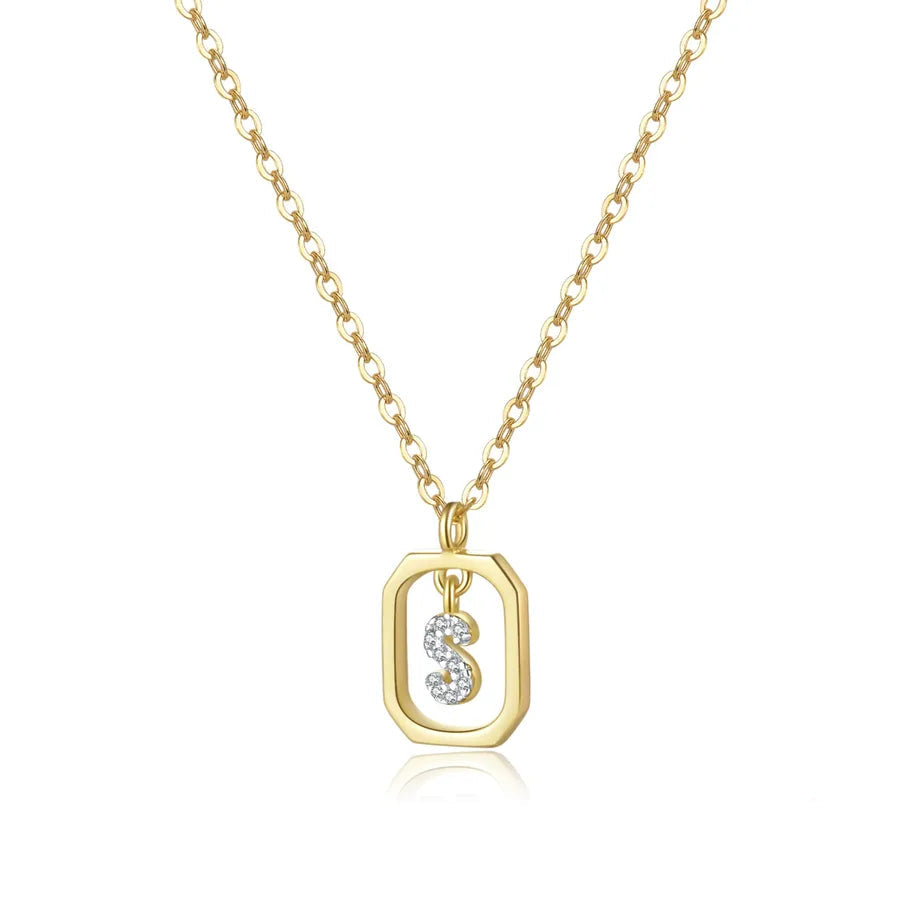 Gold necklace with a pendant featuring a letter 'S' on a white background