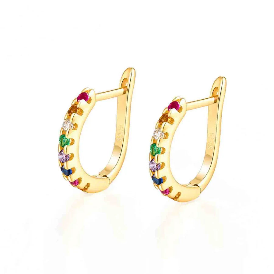 A pair of gold huggie hoop earrings decorated with small colorful gemstones, shown on a clean white background.