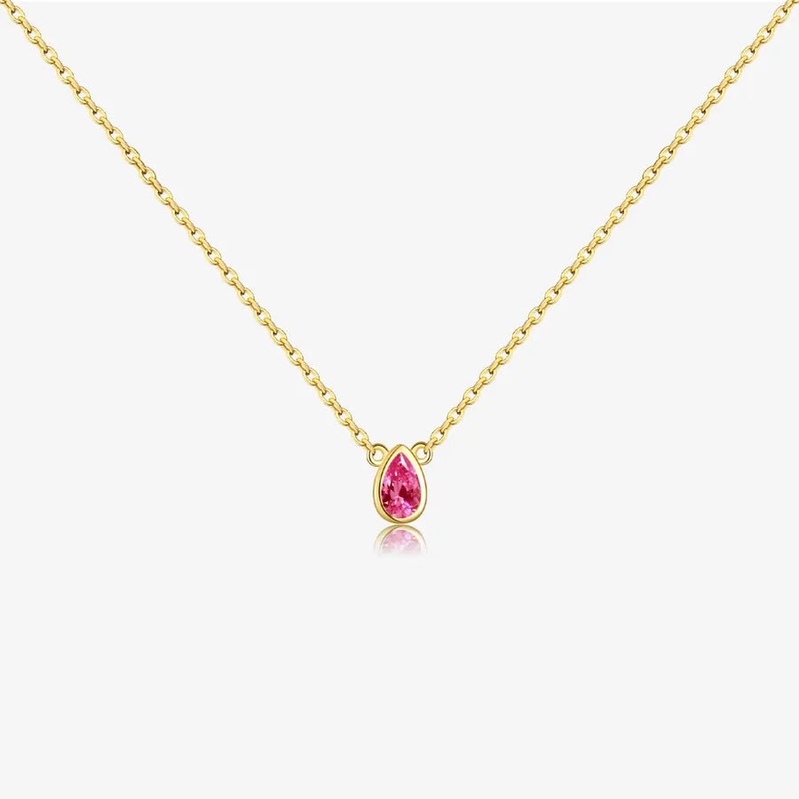 Gold necklace with a pink teardrop-shaped gemstone on a white background