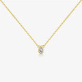Gold necklace with a teardrop-shaped diamond pendant on a white background