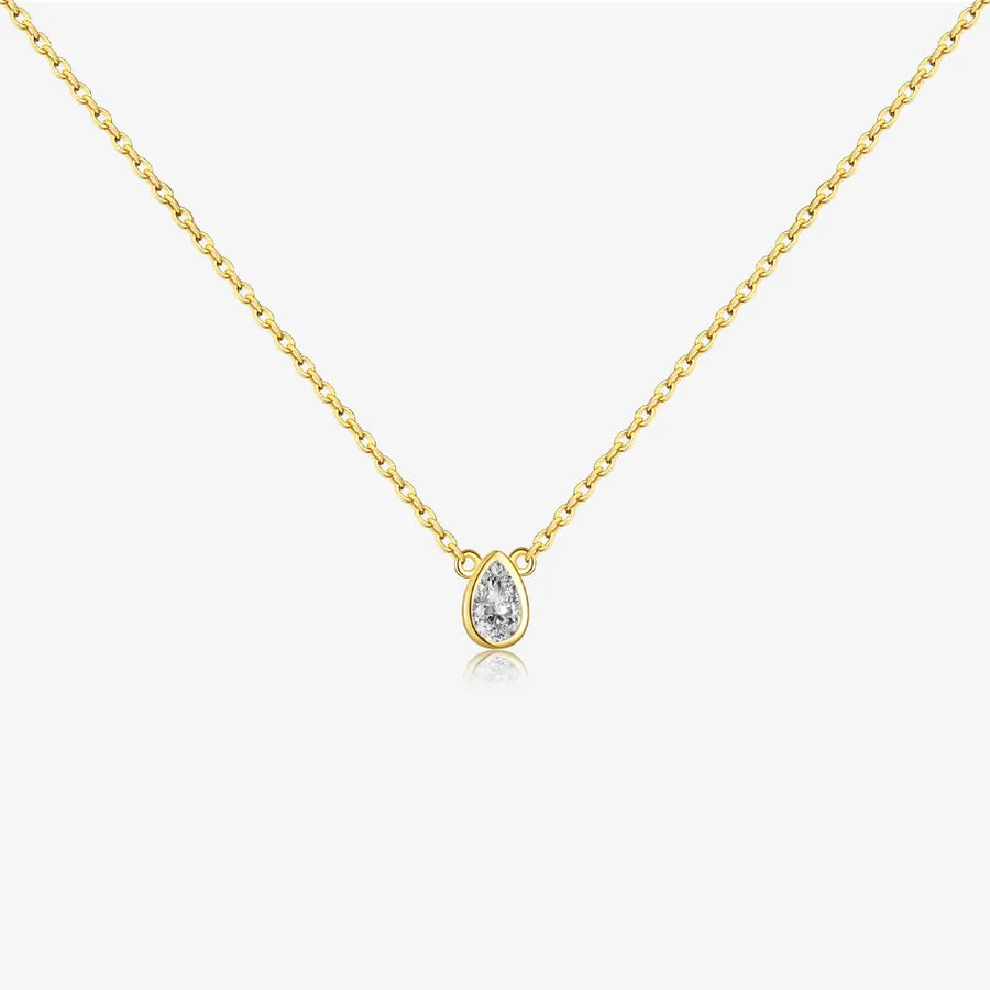 Gold necklace with a teardrop-shaped diamond pendant on a white background