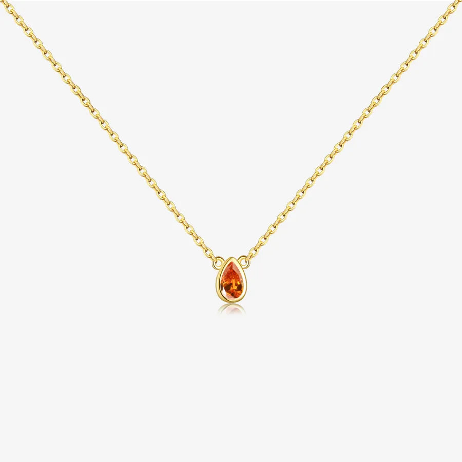Gold necklace with a teardrop-shaped orange gemstone on a white background